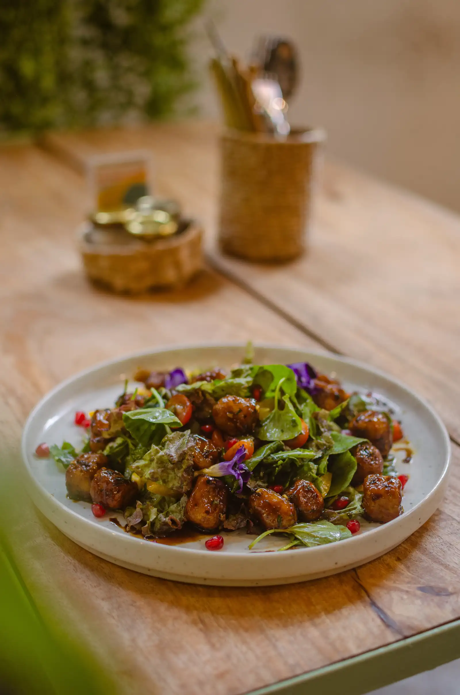 A glazed tempeh and leafy salad plate at Flow Café, Weligama