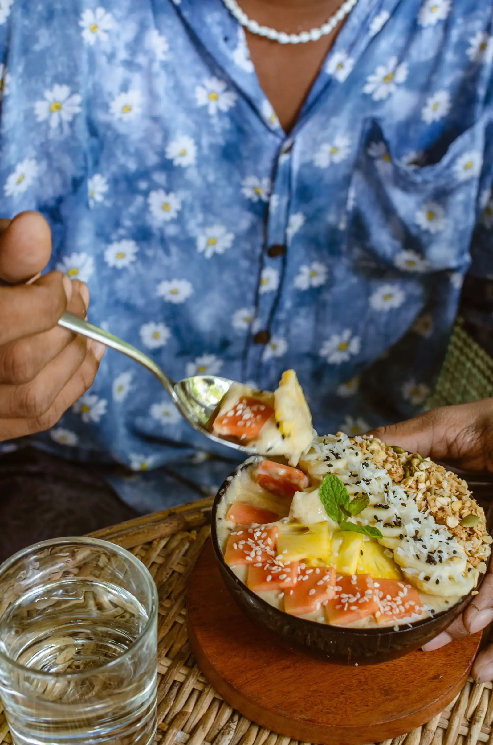 A fruit and granola bowl served in a coconut shell at Flow Café, Weligama