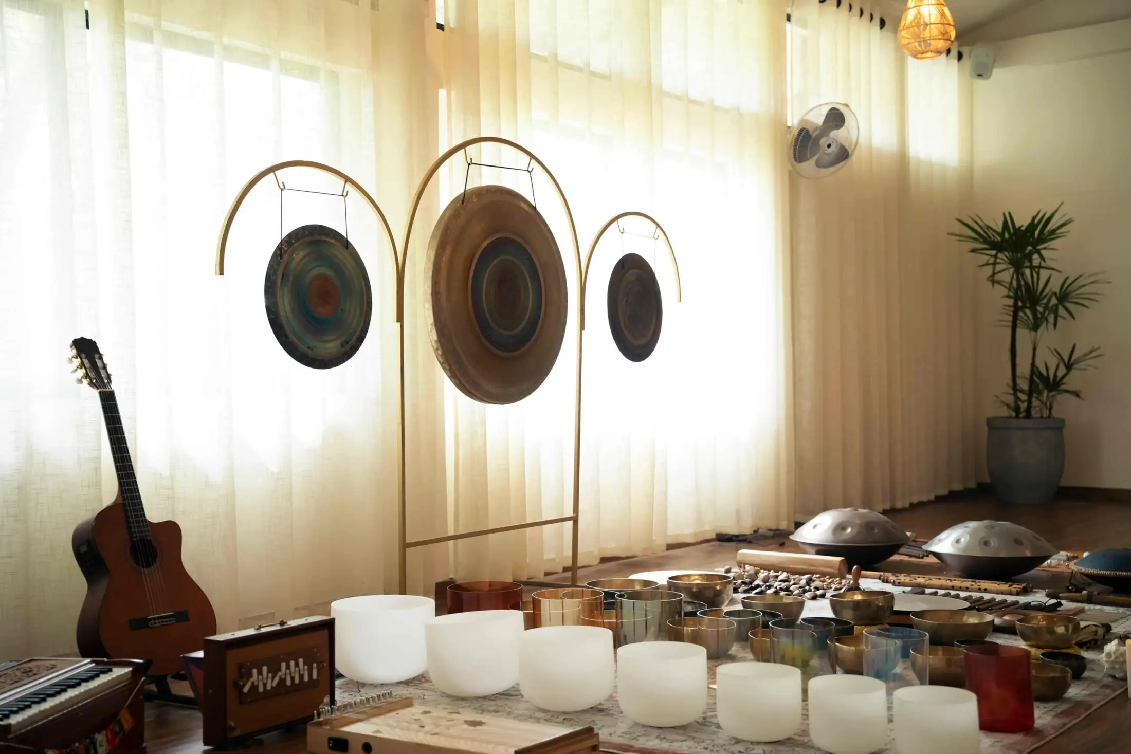 Hand-crafted gongs, handpans and crystal bowls used in sound healing at Senses