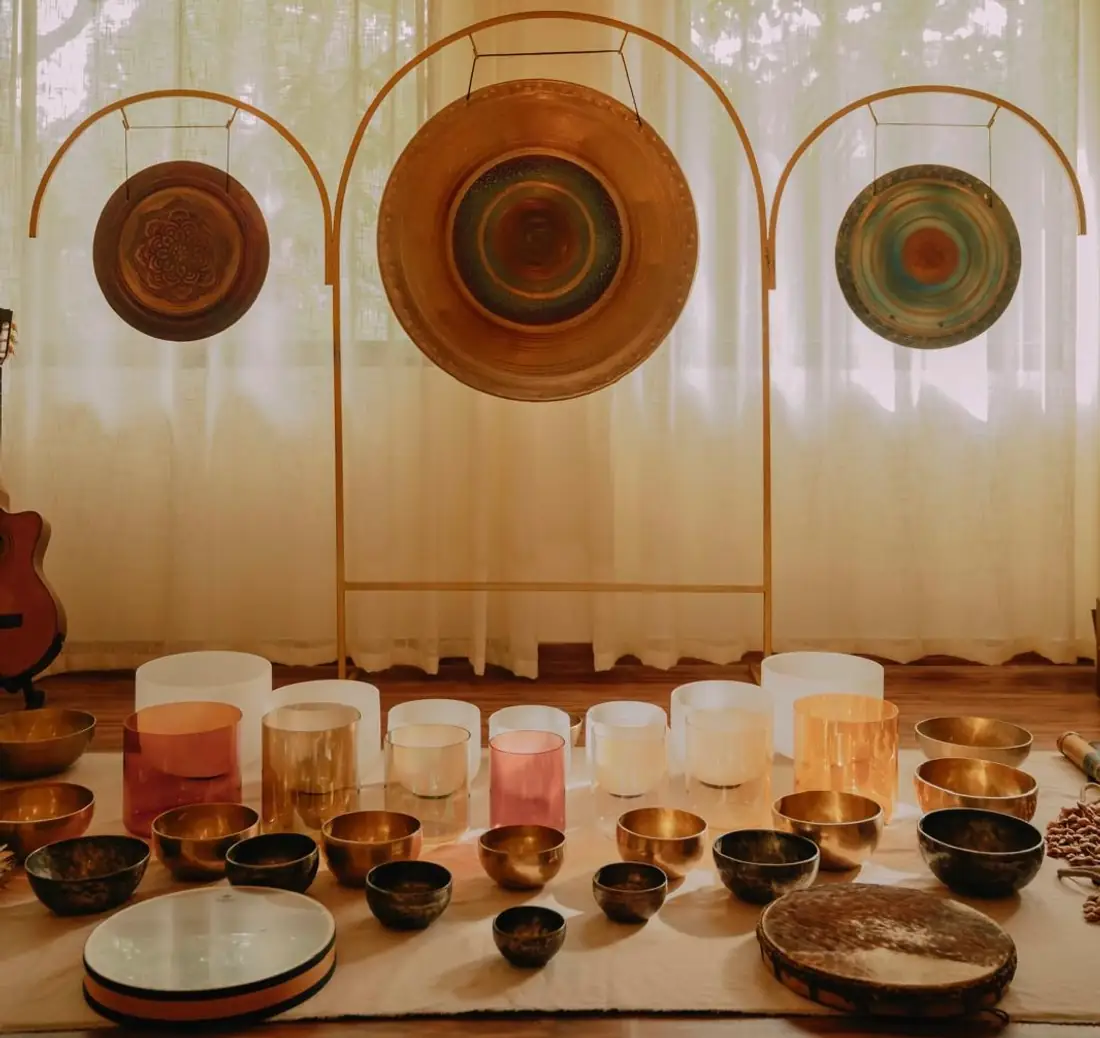 Gongs and singing bowls set up for a sound healing session at Senses