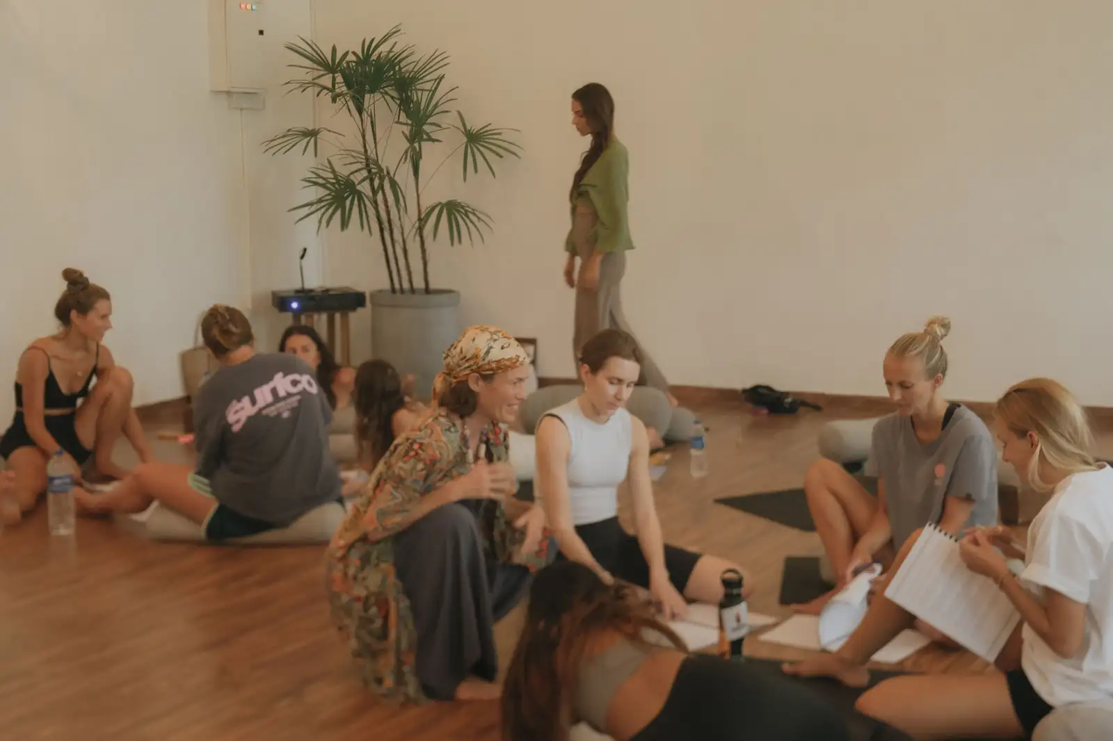 Students sitting together on the studio floor during a Yin yoga training at Senses